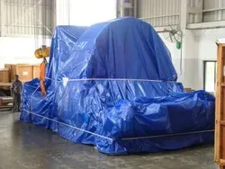 Industrial machinery covered with a blue tarpaulin